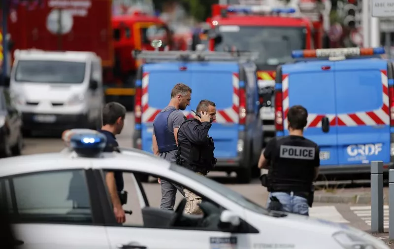 French police officers and firemen arrive at the scene of a hostage-taking at a church in Saint-Etienne-du-Rouvray, northern France, on July 26, 2016 that left the priest dead.
A priest was killed on July 26 when men armed with knives seized hostages at a church near the northern French city of Rouen, a police source said. Police said they killed two hostage-takers in the attack in the Normandy town of Saint-Etienne-du-Rouvray, 125 kilometres (77 miles) north of Paris.

 / AFP PHOTO / CHARLY TRIBALLEAU