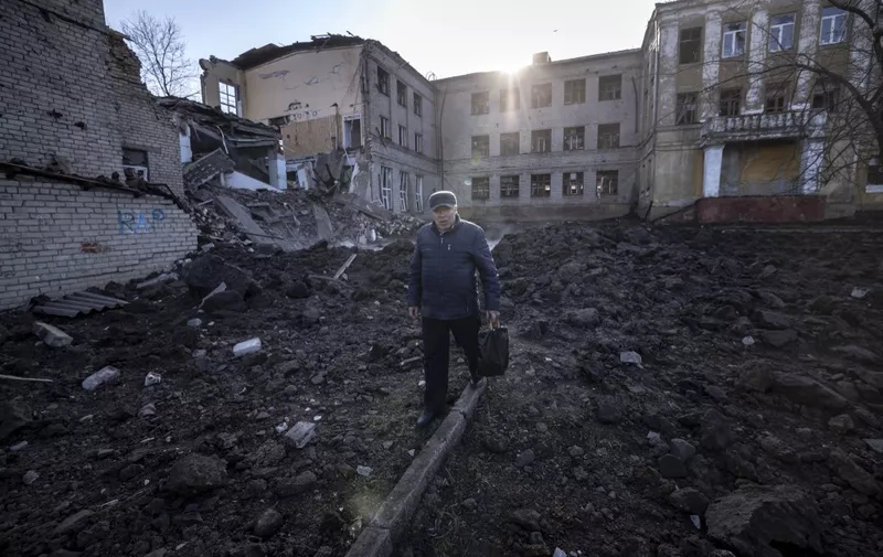 A man walks near a damaged school, next to a police building in Kramatorsk, Donbas Region of eastern Ukraine on April 5, 2022. (Photo by FADEL SENNA / AFP)