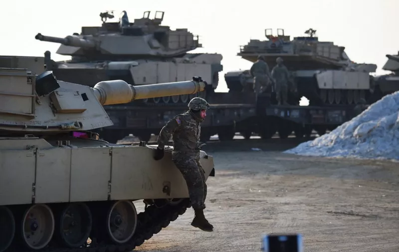 US Army personnel offload military equipment at the Mihail Kogalniceanu Air Base near Constanta in Romania on February 14, 2017. Soldiers and equipment from the 3rd Armored Brigade Combat Team, 4th Infantry Division, arrived at the Mihail Kogalniceanu Air Base as part of the ongoing Atlantic Resolve mission. The combined arms unit of the "Fighting Eagles" brings a full complement of 500 US troops, a US Army infantry battalion's M1 Abrams tanks, M2 Bradley fighting vehicles, and M109A6 Paladin self-propelled howitzers to Romania. (Photo by DANIEL MIHAILESCU / AFP)