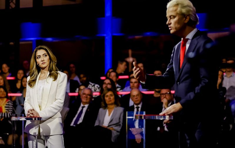 Minister of Justice and Security for the Netherlands and Leader of the People's Party for Freedom and Democracy Dilan Yesilgoz (L) looks towards Leader of the Party for Freedom Geert Wilders (R) during the final debate of the Dutch Broadcasting Foundation NOS ahead of the Netherlands' general election, in the Hague on November 21, 2023. Dutch voters head to the polls on November 22, 2023 for an election too close to call that will transform the country's political landscape after Prime Minister Mark Rutte's record 13 years in power. Opinion polls have fluctuated wildly in the run-up to election day, with any one of the four top candidates in with a genuine shot at taking the helm of the EU's fifth-biggest economy. (Photo by Remko de Waal / ANP / AFP) / Netherlands OUT