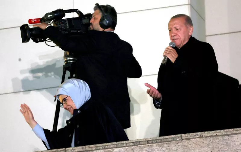 Turkish President Tayyip Erdogan (R) addresses supporters with his wife Ermine Erdogan (L) at the AK Party headquarters after polls closed in Turkey's presidental and parliamentary elections in Ankara, Turkey May 15, 2023. Turkey is braced for its first election runoff after a night of high drama showed President Recep Tayyip Erdogan edging ahead of his secular rival but failing to secure a first-round win. (Photo by Adem ALTAN / AFP)