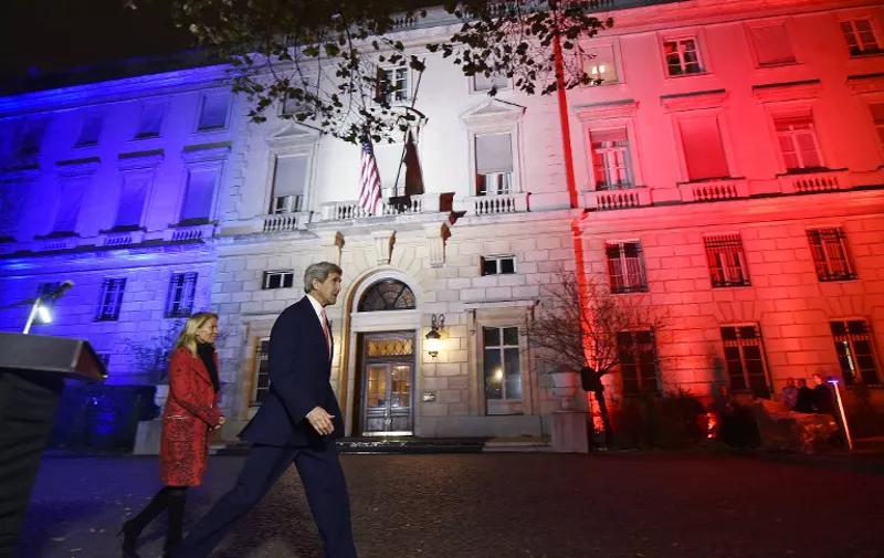 US Secretary of State John Kerry (C), next to US ambassador to France Jane D. Hartley, leaves after delivering a speech at the US embassy illuminated with the colors of the French national flag on November 16, 2015 in Paris . John Kerry will meet French President Francois Hollande in Paris early on November 17, the French presidency said. They will hold talks at the Elysee Palace in the wake of November 13 jihadist attacks on Paris that left 129 dead, a statement said.  AFP PHOTO / POOL / DOMINIQUE FAGET