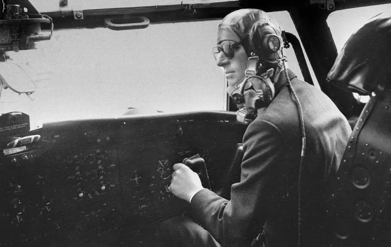 FILE - In this April 11, 1956 file photo the Duke of Edinburgh controls a Blackburn military transport plane a few minutes before a fire extinguisher burst and filled the cockpit with choking fumes. Buckingham Palace says Prince Philip, husband of Queen Elizabeth II, has died aged 99. (AP Photo/File)