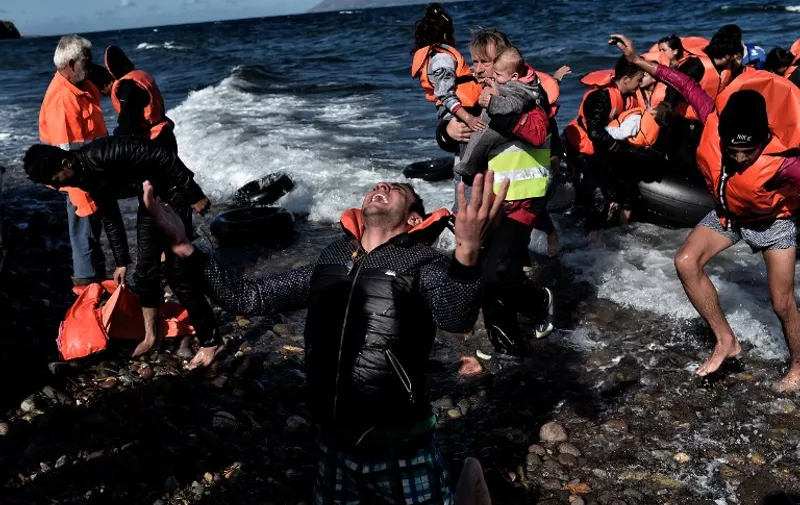 -- AFP PICTURES OF THE YEAR 2015 --
A man reacts as he arrives, with other refugees and migrants, on the Greek island of Lesbos, on October 28, 2015, after crossing the Aegean sea from Turkey. At least five migrants including three children, died on October 28, 2015 after four boats sank between Turkey and Greece, as rescue workers searched the sea for dozens more, the Greek coastguard said. The new accidents brought to 34 the number of migrants found dead in Greek waters this month, according to an AFP tally based on data from Greek port police. Since the start of the year, 560,000 migrants and refugees have arrived in Greece by sea, out of over 700,000 who have reached Europe via the Mediterranean, according to the International Office for Migration (IOM). AFP PHOTO / ARIS MESSINIS / AFP / ARIS MESSINIS