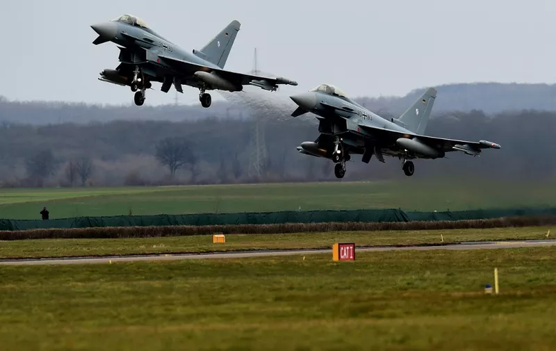 Eurofighters take off for a demonstration flight during a visit of German chancellor Angela Merkel (unseen) at the German Air Force airbase Noervenich, near Cologne, on March 21, 2016. (Photo by PATRIK STOLLARZ / AFP)