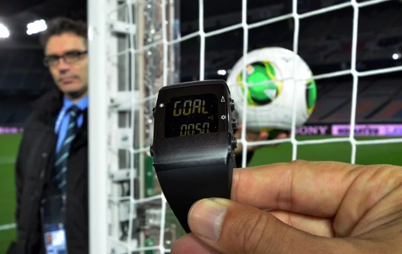 A FIFA official displays new goal-line technology, developed by GoalRef, for the press in Yokohama on December 5, 2012 ahead the Club World Cup football tournament beginning on December 6. The wrist watch displays "goal" and vibrates whenever the ball enters the goal. Referees can reject the use of goal-line technology or even overrule it in the Club World Cup, which starts this week in Japan, a senior FIFA official said on December 5. AFP PHOTO / Yoshikazu TSUNO / AFP / YOSHIKAZU TSUNO