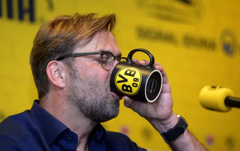 Dortmund&#8217;s head coach Juergen Klopp drinks during a press conference on April 15, 2015 in Dortmund, western Germany, to announce that he will step down as coach of German first division Bundesliga football club Borussia Dortmund (BVB). Klopp will quit as head coach at the end of the season after seven years in charge and [&hellip;]