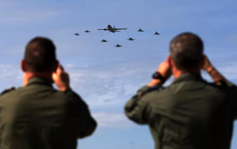 Soldiers take pictures of military aircrafts taking part in the opening ceremony of NATOs large scale exercise Trident Juncture 2015 at the Italian Air Force Base in Trapani, Sicily.  AFP PHOTO / MARCELLO PATERNOSTRO