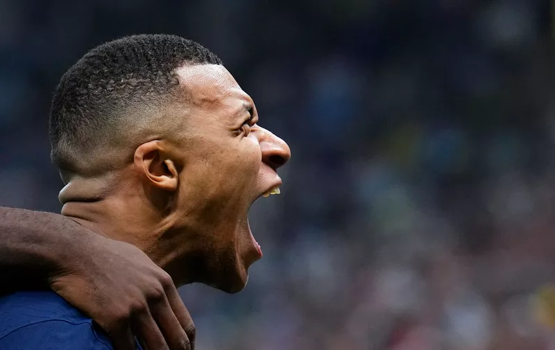 France's Kylian Mbappe celebrates scoring his side's second goal during the World Cup final soccer match between Argentina and France at the Lusail Stadium in Lusail, Qatar, Sunday, Dec. 18, 2022. (AP Photo/Natacha Pisarenko)