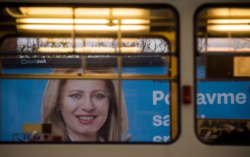 A picture taken on March 29, 2019 in Bratislava shows a billboard bearing a portrait of presidential candidate Zuzana Caputova and reading "Stand up against evil, together we can do it". - Zuzana Caputova, a Slovak government critic who will face off against the ruling party's candidate in the second round of presidential elections, is a liberal lawyer hoping to become the EU member's first female head of state. (Photo by VLADIMIR SIMICEK / AFP)
