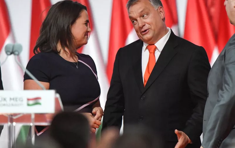 (FILES) Reelected chairman of the governing FIDESZ party, Hungarian Prime Minister Viktor Orban, reacts on the podium beside then elected party deputy-chairman, Hungarian Minister of State for Family and Youth Affairs Katalin Novak (L), during the party congress at the Hungexpo fair center in Budapest on November 12, 2017. Hungarian President Katalin Novak, a close ally of Prime Minister Viktor Orban, announced her resignation on February 10, 2024 following outrage over a pardon granted to a man implicated in a child sexual abuse case. (Photo by ATTILA KISBENEDEK / AFP)