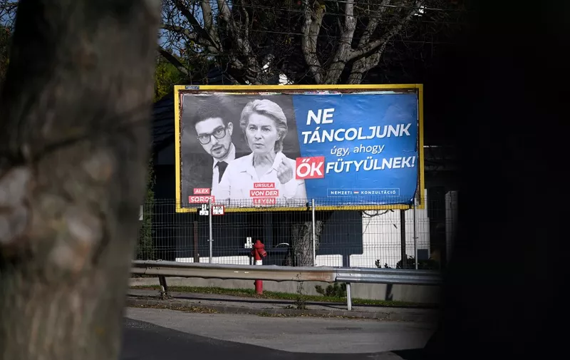 A new billboard showing European Commission President Ursula von der Leyen and Alexander Soros, son of Hungarian-US billionaire George Soros, with the lettering "Let's not dance to their tunes! National consultation", is pictured in Budapest, Hungary, on November 22, 2023. The Hungarian government on November 17, 2023 launched a "national consultation" billed as "protecting" the country against alleged European Union policies, including war-torn Ukraines potential membership of the bloc. Prime Minister Orban's nationalist government has, since 2015, frequently used such questionnaires, backed by extensive multimedia campaigns, to claim legitimacy for its positions and to attack EU policies. (Photo by ATTILA KISBENEDEK / AFP)