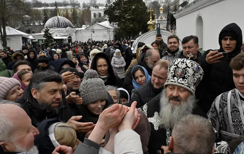 Metropolitan Pavlo, running the Lavra, blesses believers of the Ukrainian Orthodox Church at the historic Kyiv-Pechersk Lavra in Kyiv on March 29, 2023.23. - Hundreds of worshippers attended a service on March 29, 2023 at a historic Kyiv monastery accused of maintaining links with Moscow as the deadline for the eviction of its monks dawned. The government announced it was terminating the lease that allowed the monks to occupy part of the Kyiv-Pechersk Lavra for free, giving them until March 29 to leave. (Photo by SERGEI CHUZAVKOV / AFP)