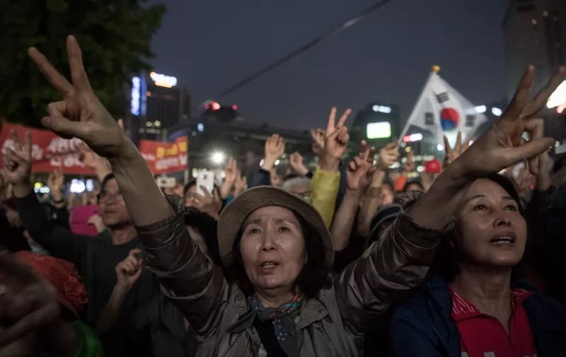 Supporters of South Korean presidential candidate Hong Jun-Pyo gesture and shout slogans as they listen to a speech during a campaign rally in Seoul on May 8, 2017.
South Korea's presidential hopefuls made a final push for votes on May 8, with the left-leaning candidate a clear favourite, as the North assailed the outgoing conservative government a day before the polls. / AFP PHOTO / Ed JONES