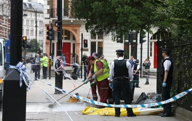 The crime scene is cleaned in London's Russell Square on August 4, 2016, following a knife attack in which one woman was killed and five others injured. 
A woman was killed and five people injured in a knife attack in central London Wednesday which police said they are investigating for possible terrorist links. A 19-year-old man was arrested in Russell Square, in the city centre, which was cordoned off after the attack as police swarmed the area.
 / AFP PHOTO / JUSTIN TALLIS