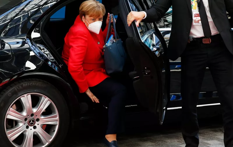 Germany's Chancellor Angela Merkel, wearing a protective face mask, gets out of a car as she arrives for a meeting during an EU summit at the European Council building in Brussels, on July 20, 2020, as the leaders of the European Union hold their first face-to-face summit over a post-virus economic rescue plan. - The 27 EU leaders gather for another session of talks after three days and nights of prolonged wrangling failed to agree a 750-billion-euro ($860-billion) bundle of loans and grants to drag Europe out of the recession caused by the coronavirus pandemic (COVID-19). (Photo by FRANCOIS LENOIR / POOL / AFP)