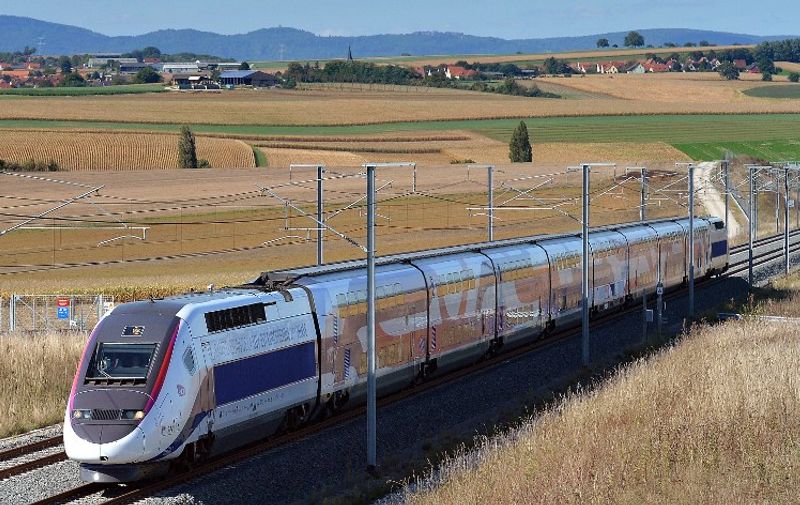 A TGV high speed train passes on the East-European LGV line during a test on September 28, 2016 in Gougenheim, eastern France. 106 kms of new track have been laid between Baudrecourt (Moselle) and Vendenheim (Bas-Rhin) for high-speed transit that will save another 30 minutes off of the 2 hours and 20 minutes trip between Paris and Strasbourg. The line will be put into operation on April 3, 2016. AFP PHOTO / PATRICK HERTZOG