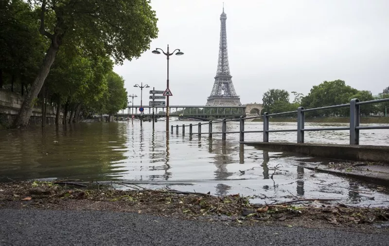 A photo shows the Eiffel tower and the flooded banks of the river Seine following heavy rainfalls in Paris on June 2, 2016.

Torrential downpours have lashed parts of northern Europe in recent days, leaving four dead in Germany, breaching the banks of the Seine in Paris and flooding rural roads and villages. / AFP PHOTO / Geoffroy Van der Hasselt