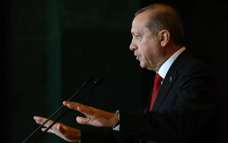 A handout picture taken and released by Turkish presidential press office on January 12, 2016 shows Turkish President Recep Tayyip Erdogan delivering a speech during the Ambassador's Conference at the Presidential Complex in Ankara.
Turkish President Recep Tayyip Erdogan said today's attack on Istanbul's tourist heart that killed 10 people and wounded 15 was carried out by a suicide bomber of Syrian origin and foreigners were among the dead. / AFP / TURKISH PRESIDENTIAL PRESS OFFICE / KAYHAN OZER / RESTRICTED TO EDITORIAL USE - MANDATORY CREDIT "AFP PHOTO /TURKSIH PRESIDENTIAL PRESS OFFICE /KAYHAN OZER" - NO MARKETING NO ADVERTISING CAMPAIGNS - DISTRIBUTED AS A SERVICE TO CLIENTS