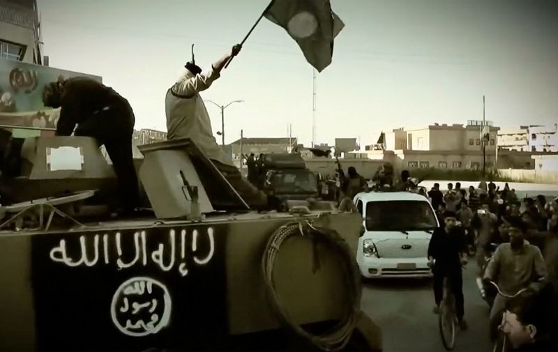 An image grab taken from a propaganda video released on March 17, 2014 by the Islamic State of Iraq and the Levant (ISIL)'s al-Furqan Media allegedly shows ISIL fighters the trademark Jihadists flag as they stand on an armoured vehicle at an undisclosed location in the Anbar province. The jihadist Islamic State of Iraq and the Levant group has spearheaded a major offensive that began on June 9, 2014 and has since overrun all of Iraq's northern Nineveh province. AFP PHOTO / HO / AL-FURQAN MEDIA 
=== RESTRICTED TO EDITORIAL USE - MANDATORY CREDIT "AFP PHOTO / HO / AL-FURQAN MEDIA" - NO MARKETING NO ADVERTISING CAMPAIGNS - DISTRIBUTED AS A SERVICE TO CLIENTS FROM ALTERNATIVE SOURCES, AFP IS NOT RESPONSIBLE FOR ANY DIGITAL ALTERATIONS TO THE PICTURE'S EDITORIAL CONTENT, DATE AND LOCATION WHICH CANNOT BE INDEPENDENTLY VERIFIED ===