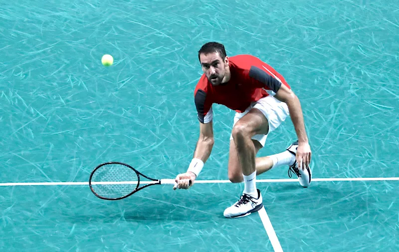 Croatia's Marin Cilic returns the ball to Australia's Alex de Minaur during the first semi-final Davis Cup tennis match between Australia and Croatia in Malaga, Spain, Friday, Nov. 25, 2022. (AP Photo/Joan Monfort)