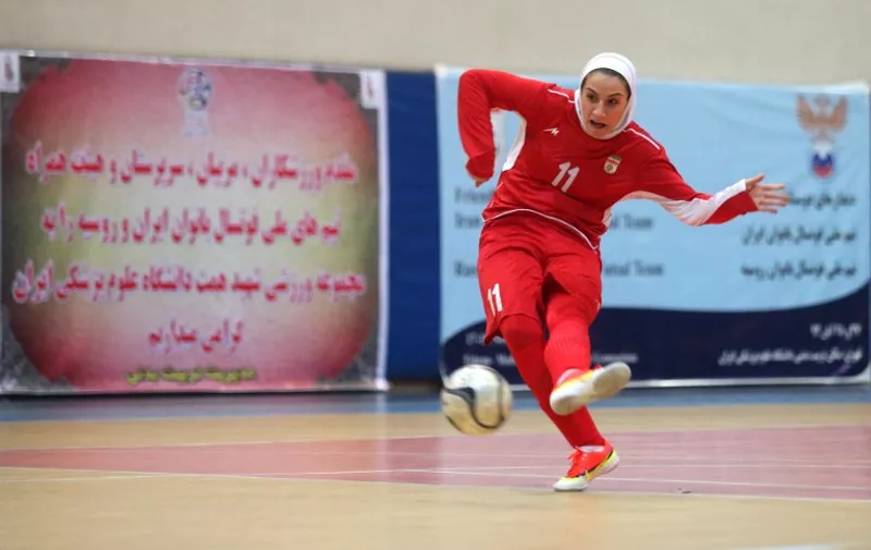 (FILES) A file photo taken on December 3, 2014 shows Iranian women's football captain Niloofar Ardalan during a practice session in Tehran. The Iranian women's football team will be minus its captain, Ardalan, at the Asian championship in Malaysia in September 2015 after her husband invoked his right under Islamic law to bar her from travelling.I  / AFP / ISNA / AMIR KHOLOOSI