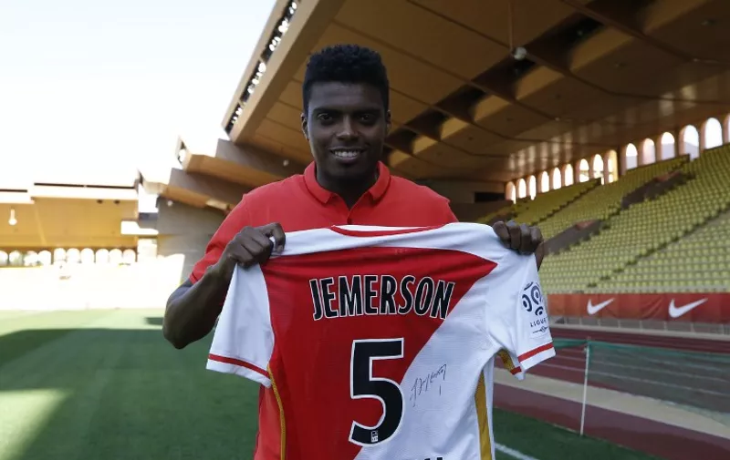 Monaco's Brazilian defender Jemerson holds  up his team shirt on February 4, 2016 at Louis II stadium in Monaco. 
Monaco sealed a deal to bring Jemerson, 23-years-old, to the principality on a four-and-a-half year contract from Atletico Mineiro in his native Brazil. / AFP / VALERY HACHE