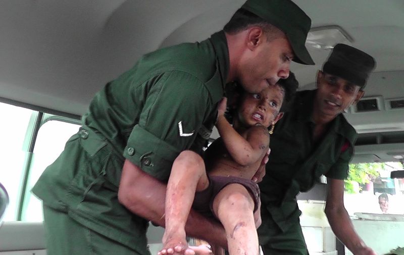 Soldiers evacuate an injured child after they raid what believed to be an Islamist safe house in the eastern town of Kalmunai on April 27, 2019. Fifteen people, including six children, died during a raid by Sri Lankan security forces as three cornered suicide bombers blew themselves up and others were shot dead, police said on April 27., Image: 429110794, License: Rights-managed, Restrictions: , Model Release: no, Credit line: Profimedia, AFP