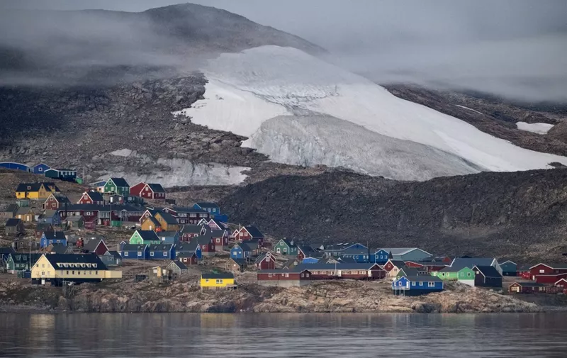 This photograph taken on August 17, 2023, shows the Eastern Greenland remote village of Ittoqqortoormiit, that has a population of approximately 300 inhabitants, in Scoresby Sound Fjord, Eastern Greenland. (Photo by Olivier MORIN / AFP)
