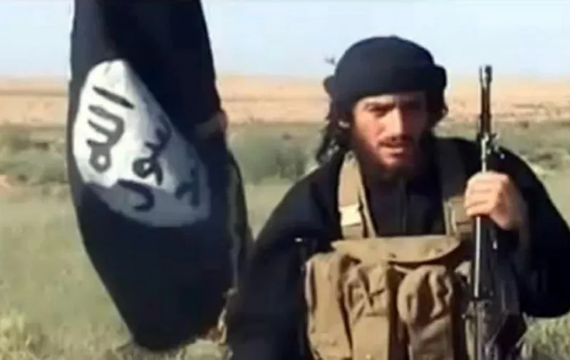 An image grab taken from a video uploaded on YouTube on July 8, 2012, shows the spokesman for the Islamic State of Iraq and the Levant (ISIL), Abu Mohammad al-Adnani al-Shami, speaking next to an Al-Qaeda-affiliated flag at an undisclosed location. AFP PHOTO / YOUTUBE == RESTRICTED TO EDITORIAL USE - MANDATORY CREDIT "AFP PHOTO / YOUTUBE " - NO MARKETING NO ADVERTISING CAMPAIGNS - DISTRIBUTED AS A SERVICE TO CLIENTS FROM FROM ALTERNATIVE SOURCES, THEREFORE AFP IS NOT RESPONSIBLE FOR ANY DIGITAL ALTERATIONS TO THE PICTURE'S EDITORIAL CONTENT, DATE AND LOCATION WHICH CANNOT BE INDEPENDENTLY VERIFIED / AFP PHOTO / YouTube / -