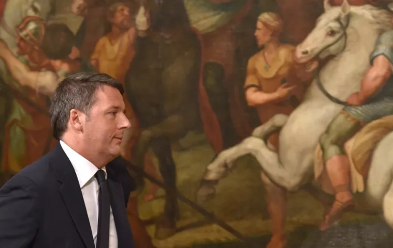 Italy's Prime Minister Matteo Renzi leaves after he announced his resignation during a press conference at the Palazzo Chigi following the results of the vote for a referendum on constitutional reforms, on December 5, 2016 in Rome. "My experience of government finishes here," Renzi told a press conference after the No campaign won what he described as an "extraordinarily clear" victory in the referendum on which he had staked his future.
 / AFP PHOTO / Andreas SOLARO / The erroneous mention[s] appearing in the metadata of this photo by Andreas SOLARO has been modified in AFP systems in the following manner: [December 5, 2016] instead of [December 4, 2016]. Please immediately remove the erroneous mention[s] from all your online services and delete it (them) from your servers. If you have been authorized by AFP to distribute it (them) to third parties, please ensure that the same actions are carried out by them. Failure to promptly comply with these instructions will entail liability on your part for any continued or post notification usage. Therefore we thank you very much for all your attention and prompt action. We are sorry for the inconvenience this notification may cause and remain at your disposal for any further information you may require.