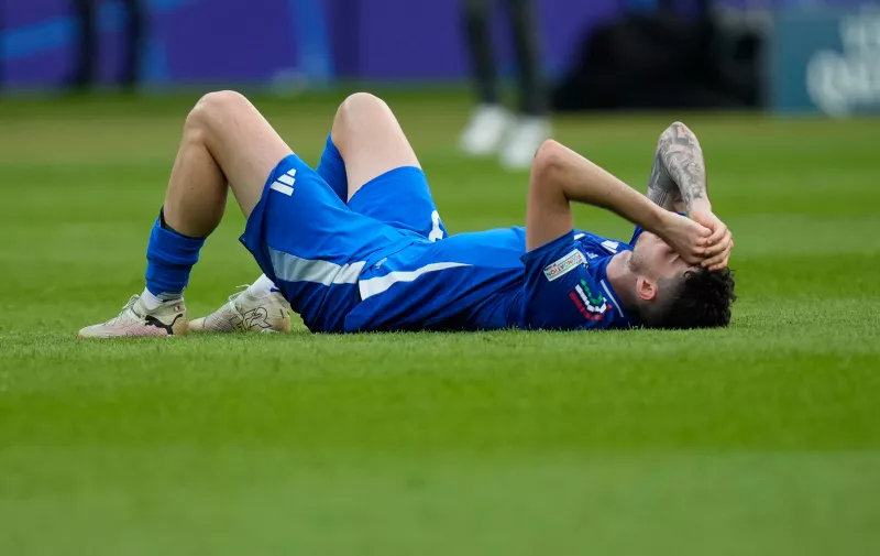 Italy's Mattia Zaccagni lies on the pitch at the end of a round of sixteen match between Switzerland and Italy at the Euro 2024 soccer tournament in Berlin, Germany, Saturday, June 29, 2024. Switzerland won the game 2-0. (AP Photo/Ariel Schalit)