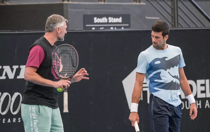 Serbian tennis player Novak Djokovic talks to his coach Goran Ivanisevic during a practice session ahead of the ATP Adelaide International tournament, in Adelaide on December 30, 2022. (Photo by Brenton EDWARDS / AFP)