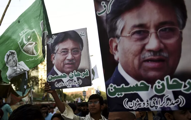 Demonstrators carry pictures of former military ruler Pervez Musharraf, during a protest following a special court's verdict, in Karachi on December 24, 2019. - Exiled former Pakistani military leader Pervez Musharraf was sentenced to death on December 17 after being found guilty of treason, a verdict swiftly condemned by the armed forces which have ruled the country for almost half its 72-year history. (Photo by Rizwan TABASSUM / AFP)