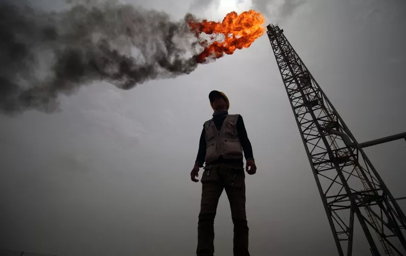 An employee stands at the Hammar Mushrif new Degassing Station Facilities site inside the Zubair oil and gas field, north of the southern Iraqi province of Basra on May 9, 2018. (Photo by HAIDAR MOHAMMED ALI / AFP)