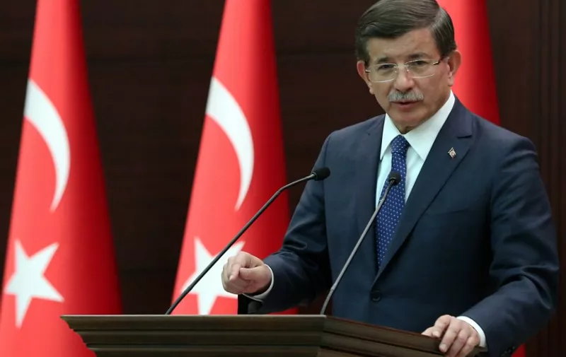 A hand out image nade available by the Turkish Prime Minister office on July 20, 2015, shows Prime Minister  Ahmet Davutoglu holding a press conference on July 20, 2015, in Ankara, following a suicide bombing in Suruc, a town opposite the Syrian flashpoint of Kobane -- which was itself later hit by a suicide car bombing. A suicide bomber attacked a cultural centre hosting anti-Islamic State activists in a Turkish town near the border with Syria, killing 30 people in an "act of terror" blamed on the jihadist group. AFP PHOTO / PRIME MINISTER'S OFFICE /HALIL SAGIRKAYA

==RESTRICTED TO EDITORIAL USE - MANDATORY CREDIT "AFP PHOTO /PRIME MINISTER'S OFFICE /HALIL SAGIRKAYA" - NO MARKETING NO ADVERTISING CAMPAIGNS - DISTRIBUTED AS A SERVICE TO CLIENT - AFP IS NOT RESPONSIBLE FOR ANY DIGITAL ALTERATIONS TO THE PICTURE'S EDITORIAL CONTENT, DATE AND LOCATION ==