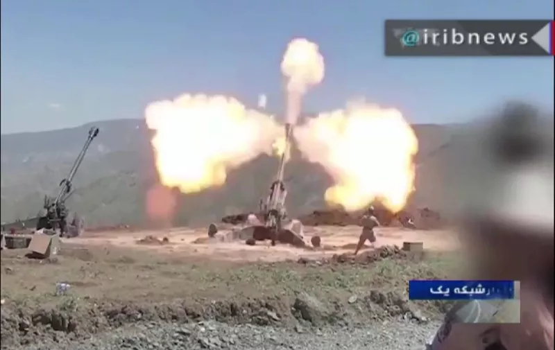 An image grab taken from a broadcast by Islamic Republic of Iran Broadcasting (IRIB) on July 12, 2019 shows artillery guns, reportedly of Iran's Islamic Revolutionary Guard Corps (IRGC), firing at an undisclosed location. - Iran's Revolutionary Guards said on July 12 that they had launched deadly strikes with rockets, drones and artillery against "terrorists" across the border in Iraqi Kurdistan. The statement did not name the groups targeted in the strikes, but said they were behind efforts to "disrupt security" in Iran. (Photo by - / IRIB / AFP)