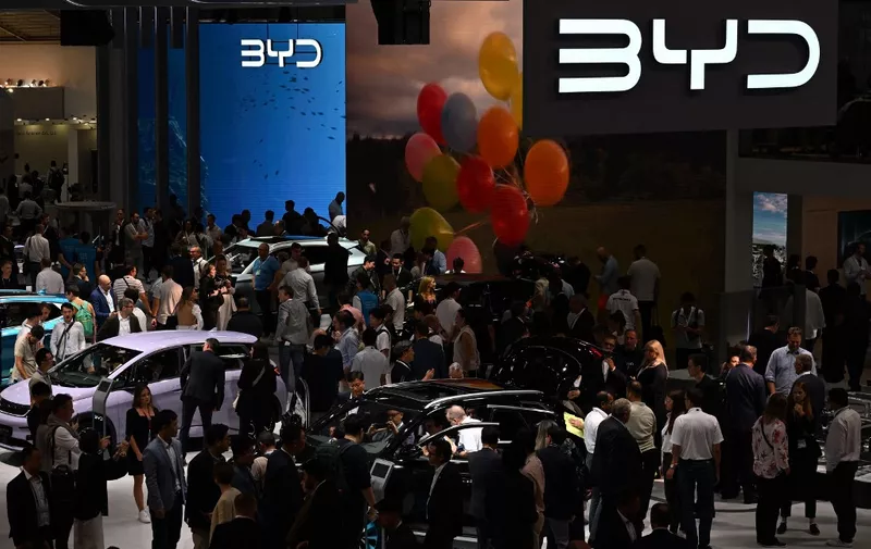 Visitors are pictured at the booth of Chinese car maker BYD presented at the International Motor Show (IAA) at the fairgrounds in Munich, southern Germany, on September 5, 2023. Germany's IAA MOBILITY auto show, one of the world's largest, will be open for the public from September 5 to 10, 2023 and showcase all car-related topics. (Photo by CHRISTOF STACHE / AFP)