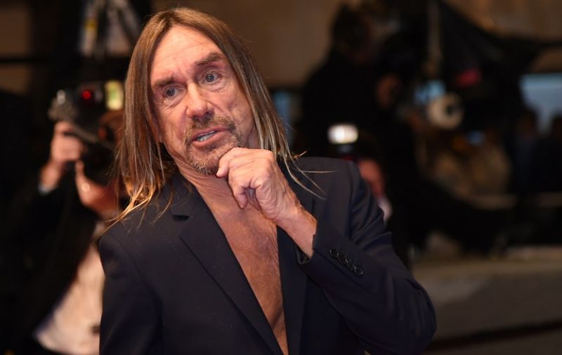 US singer Iggy Pop poses as he arrives on May 19, 2016 for the screening of the film "Gimme Danger" at the 69th Cannes Film Festival in Cannes, southern France. / AFP PHOTO / ANNE-CHRISTINE POUJOULAT