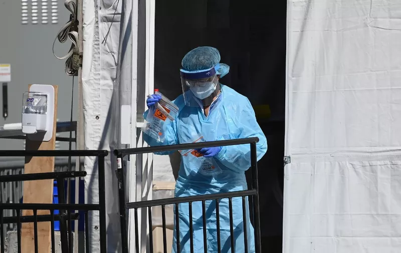 A medical worker walks out of a coronavirus, COVID-19, testing tent at Brooklyn Hospital Center on March 27, 2020 in New York City. (Photo by Angela Weiss / AFP)
