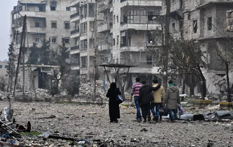 Syrian residents leave Aleppo's Bustan al-Qasr neighbourhood after pro-government forces captured the area in the eastern part of the war torn city on December 13, 2016.
After weeks of heavy fighting, regime forces were poised to take full control of Aleppo, dealing the biggest blow to Syria's rebellion in more than five years of civil war.

 / AFP PHOTO / George OURFALIAN
