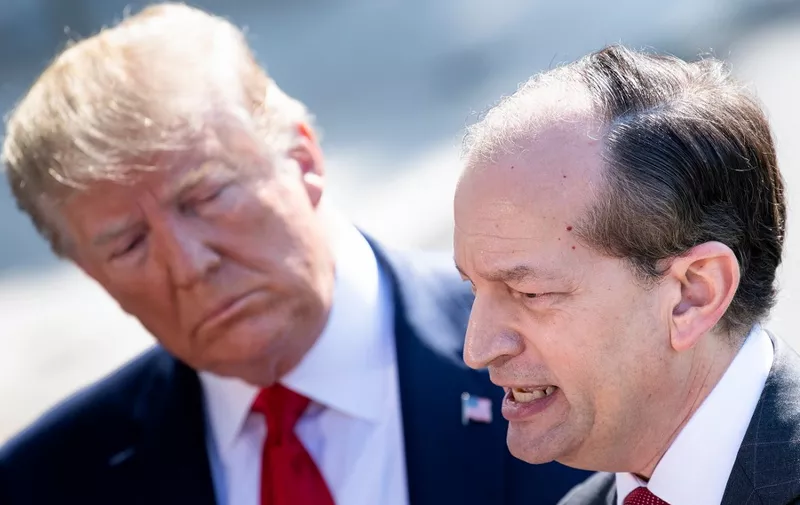 US President Donald Trump (L) listens to US Labor Secretary Alexander Acosta during a media address early July 12, 2019 at the White House in Washington, DC. - Alex Acosta announced his resignation as US labor secretary Friday, amid criticism of a secret plea deal he negotiated a decade ago with Jeffrey Epstein, the financier accused of sexually abusing young girls. "I called the president this morning and told him that I thought the right thing was to step aside," Acosta said in a joint appearance with President Donald Trump at the White House. (Photo by Brendan Smialowski / AFP)