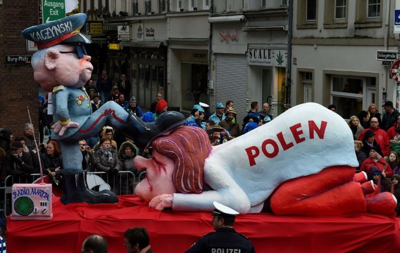 A carnival float depicting the leader of the Polish governing Law and Justice (PiS) party Jaroslaw Kaczynski (L) oppressing Poland stands in front of the city hall in Duesseldorf, western Germany, after the Rose Monday (Rosenmontag) street parade has been cancelled on February 8, 2016.
Traditional Rose Monday carnival parades in several western German cities have been cancelled due to stormy weather. / AFP PHOTO / PATRIK STOLLARZ