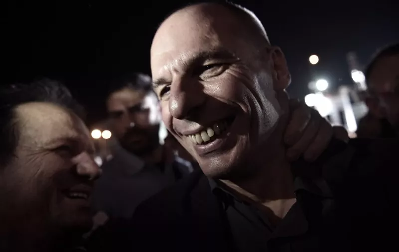 Greek Finance Minister Yanis Varoufakis is cheered by people during an address by the Greek prime minister in downtown Athens on July 3, 2015. Greek prime minister Alexis Tsipras urged voters to ignore European scaremongering and vote 'No' for Sunday's referendum as polls showed support swinging behind the 'Yes' campaign.  AFP PHOTO / ARIS MESSINIS