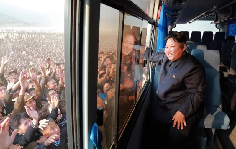 This picture released from North Korea's official Korean Central News Agency (KCNA) on October 8, 2015 shows North Korean leader Kim Jong-Un (R) waving to a crowd from a bus while inspecting a newly-built village at Paekhak-dong in Sonbong District of flood-hit Rason City.   AFP PHOTO / KCNA via KNS    REPUBLIC OF KOREA OUT
THIS PICTURE WAS MADE AVAILABLE BY A THIRD PARTY. AFP CAN NOT INDEPENDENTLY VERIFY THE AUTHENTICITY, LOCATION, DATE AND CONTENT OF THIS IMAGE. THIS PHOTO IS DISTRIBUTED EXACTLY AS RECEIVED BY AFP.
---EDITORS NOTE--- RESTRICTED TO EDITORIAL USE - MANDATORY CREDIT "AFP PHOTO / KCNA VIA KNS" - NO MARKETING NO ADVERTISING CAMPAIGNS - DISTRIBUTED AS A SERVICE TO CLIENTS