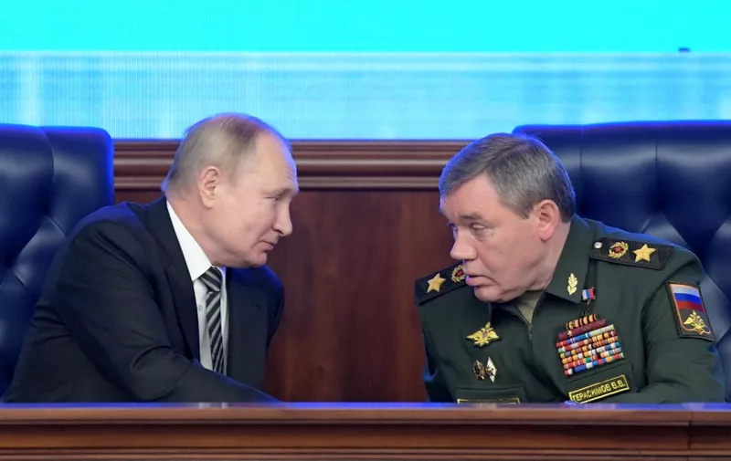 Russian President Vladimir Putin listens to Chief of the General Staff of the Russian Armed Forces Valery Gerasimov during the annual meeting of the Defence Ministry board in Moscow on December 21, 2021. (Photo by Sergei GUNEYEV / SPUTNIK / AFP)
