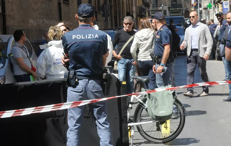 Italian police work on the site where mafia boss Giuseppe Dainotti, 67, was gunned down by two killers while riding his bike police said, on May 22, 2017 in Via d'Ossuna in Palermo, Sicily. (Photo by Alessandro FUCARINI / various sources / AFP)