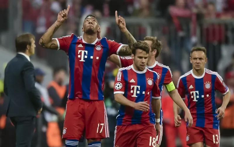 Bayern Munich&#8217;s defender Jerome Boateng celebrates scoring the 2-0 goal with his team-mates during the UEFA Champions League second-leg quarter-final football match Bayern Munich v FC Porto in Munich, southern Germany on April 21, 2015. AFP PHOTO / GUENTER SCHIFFMANN