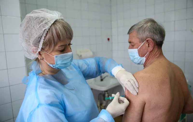 LUGANSK, UKRAINE - FEBRUARY 1, 2021: A patient receives the Gam-COVID-Vac (Sputnik V) COVID-19 vaccine at the Lugansk Republican Center of Emergency Medical Care. Alexander Reka/TASS,Image: 587850206, License: Rights-managed, Restrictions: , Model Release: no