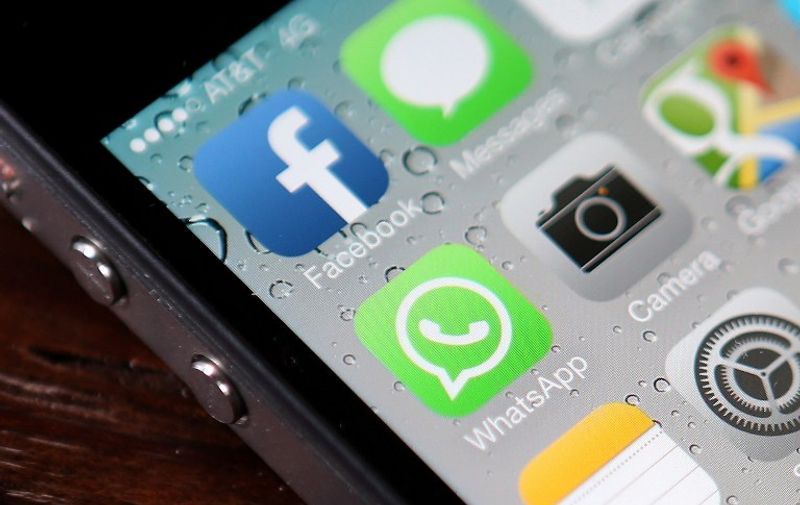 SAN FRANCISCO, CA - FEBRUARY 19: The Facebook and WhatsApp app icons are displayed on an iPhone on February 19, 2014 in San Francisco City. Facebook Inc. announced that it will purchase smartphone-messaging app company WhatsApp Inc. for $19 billion in cash and stock. (Photo illustration by Justin Sullivan/Getty Images/AFP
